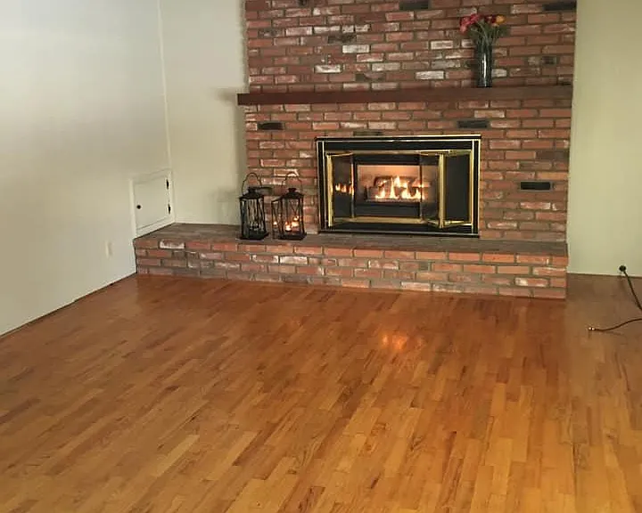 Large Family Room with hardwood floors and gas Fireplace.