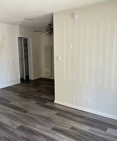 Front room view of dining area with ceiling fan in apartment at Los Robles in Pasadena, California.