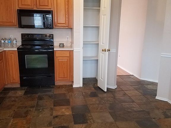 Kitchen comes with stove, microwave and dishwasher, slate flooring
