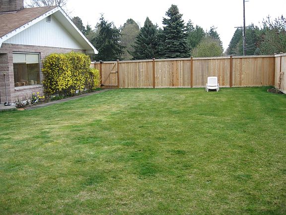 Front lawn with fenced garden