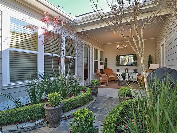 Beautiful courtyard setting! Owner had professionally designed! Enjoy coffee or wine under the covered patio!
