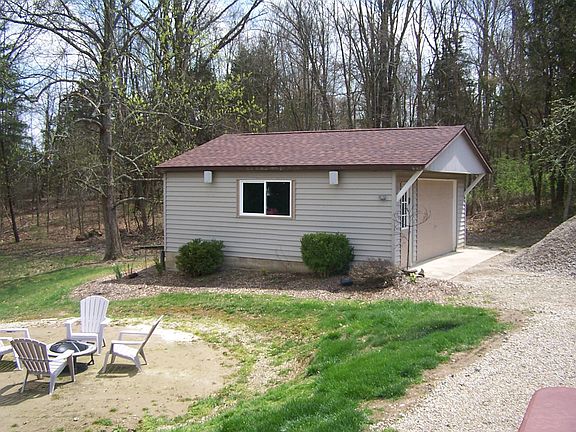 Workshop at side of home, and firepit to side and rear of ho