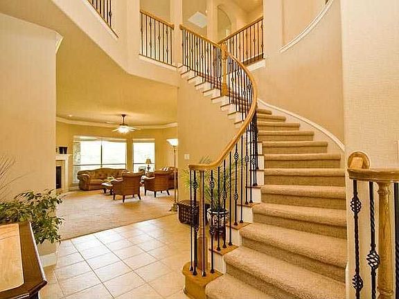 Huge Two Story Entrance w 2 Chandeliers and Winding Staircase