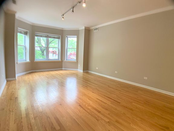 Living room 16-6 x 13-0 and large Bay Windows and hardwood flooring.