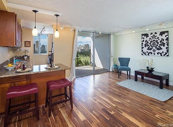 Luxurious appointments include Acacia wood flooring, lighting, granite counters and updated cabinetry.