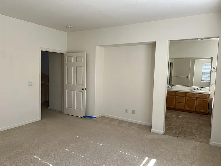Spacious Master bedroom, looking at the entrance and master bathroom with custom stone floor.