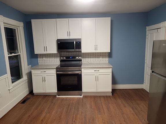Kitchen with new cabinets, range and microwave