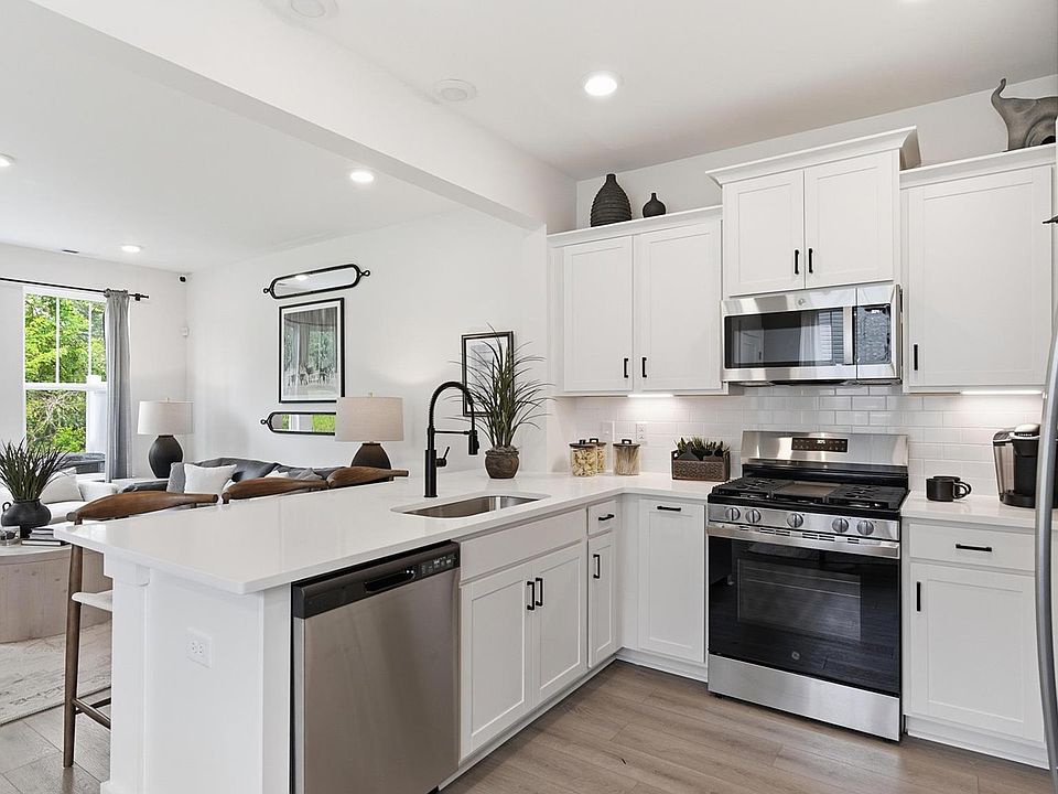 Highly skilled design choices create a clean, open kitchen with modern appliances located at Clarke