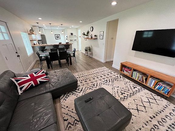 Living room with smart TV, books, and board games