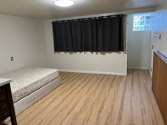 View of main studio living space, standing by closet, face front entrance to unit. (space storage area is access via the half door on the right wall, next to entrance)