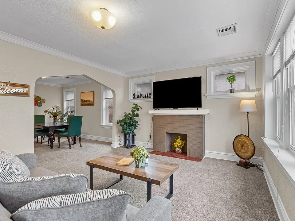 Relax and unwind in this stylish living room, complete with a large flat-screen TV. Kick back on the plush, modern sofa and catch your favorite shows or movies in high definition comfort. It's the perfect space to chill out after a day of exploring the ci