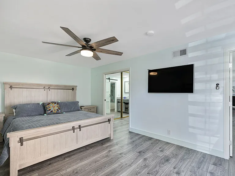Master Bedroom has a California King Size bed. There is a private bathroom and bathtub , as well a an office and wardrobe closet