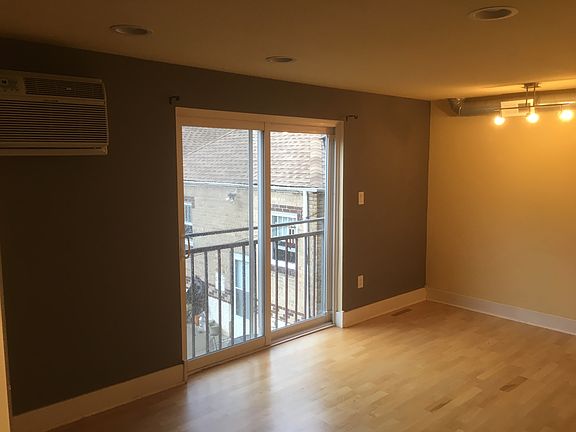 Living space with sliding door and hardwood floors