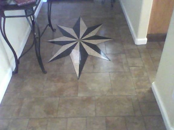 I designed and installed this  Porcelane tile/ black & rose granit inlay