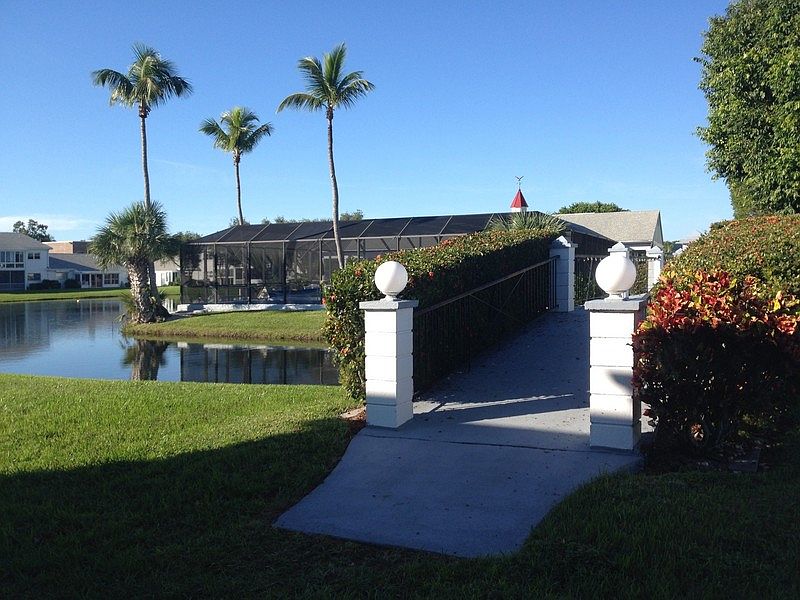 View from Lanai : Lake view with foot bridge to the pool and clubhouse 100 ft away.