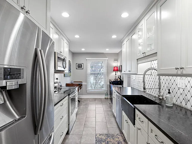 Bright galley kitchen with high-end finishes.