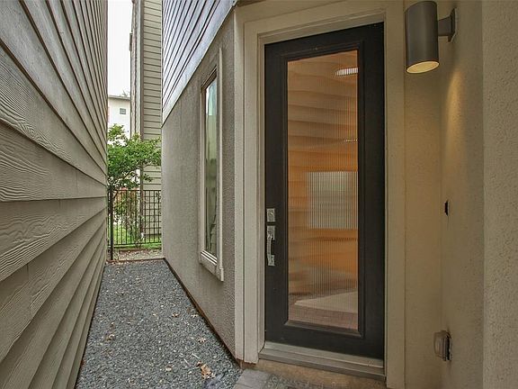 The welcoming front door with privacy glass leads to the first floor and the side window provides additional natural light to the entry foyer. Enjoy "Lock & Leave" lifestyle if desired, or settle in and get to know the surrounding neighborhood in thi