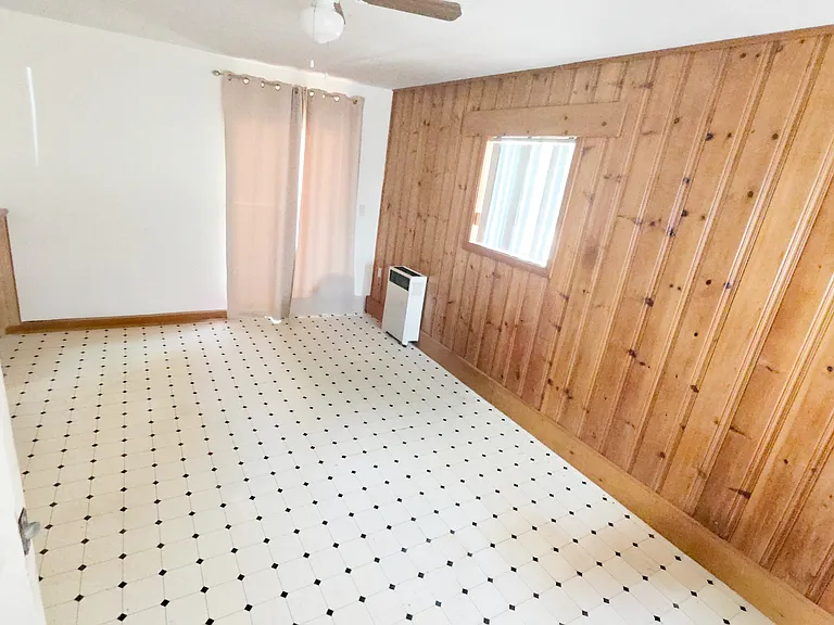 Bedroom (converted attached garage with entrance from kitchen, exterior side entrance, and rear entrance to backyard deck)