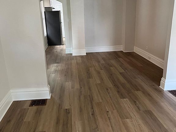 View near front door in living room, dining room, leading into the kitchen.