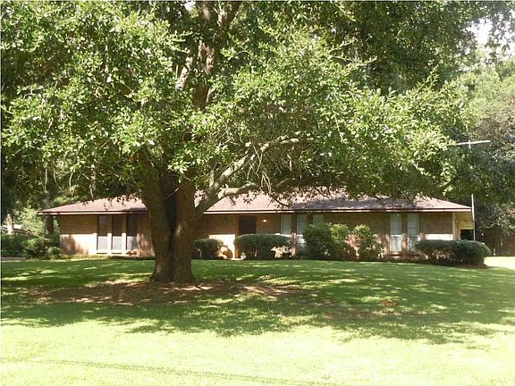 front view with large tree shaded lot
