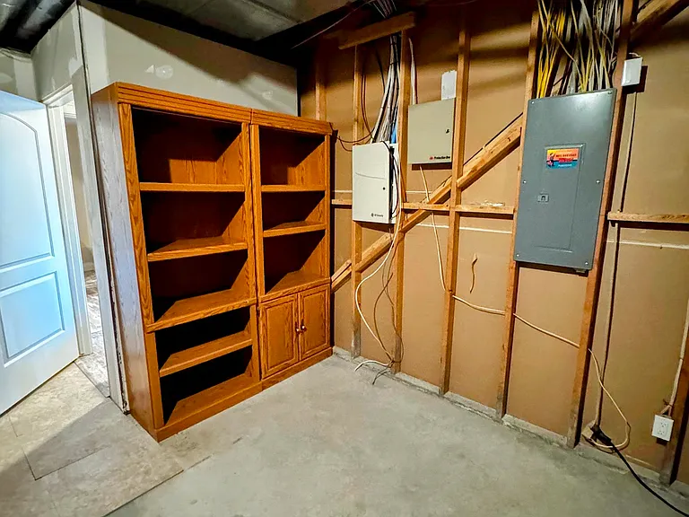 Storage room includes shelves to extend pantry space or storage.