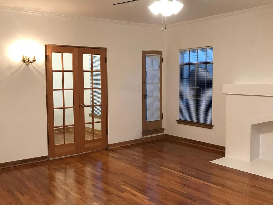 Living Room with French Doors to kitchen and balcony Three antique wall sconces