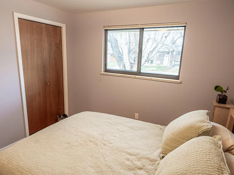 North-east view of the east bedroom from the south-west corner, showing the closet and the east-facing window.