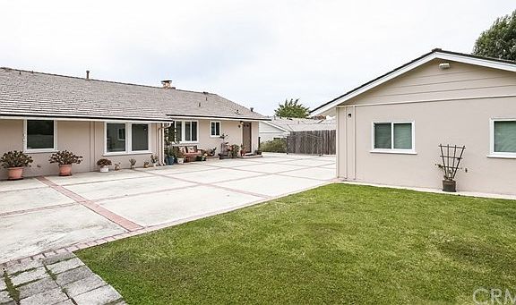View of rear of home, garage, studio and driveway