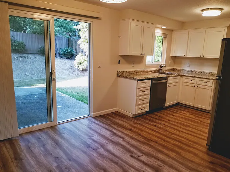 New flooring throughout house. Dining room opens onto private back patio with fenced backyard.