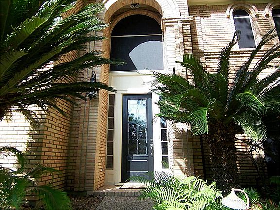 Majestic walk to the front door. Front yard boasts lush landscaping.
