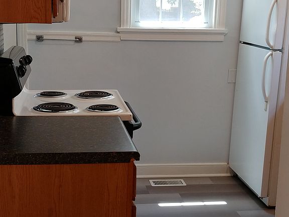 Kitchen with electric oven/range, over-the-range microhood, dishwasher, garbage disposal, and tile backsplash!