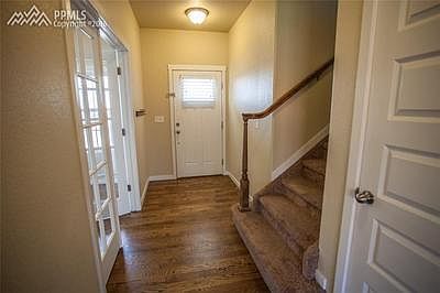 Foyer with good natural light and hard wood.