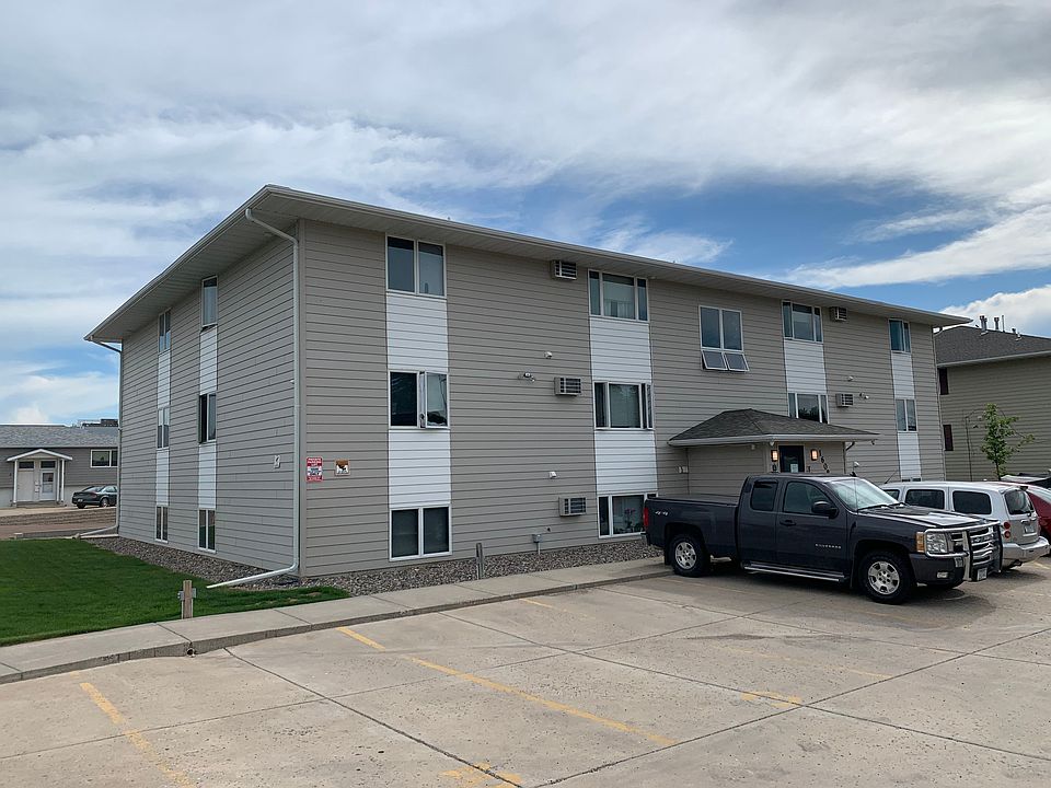 Paved parking lot and small grass section