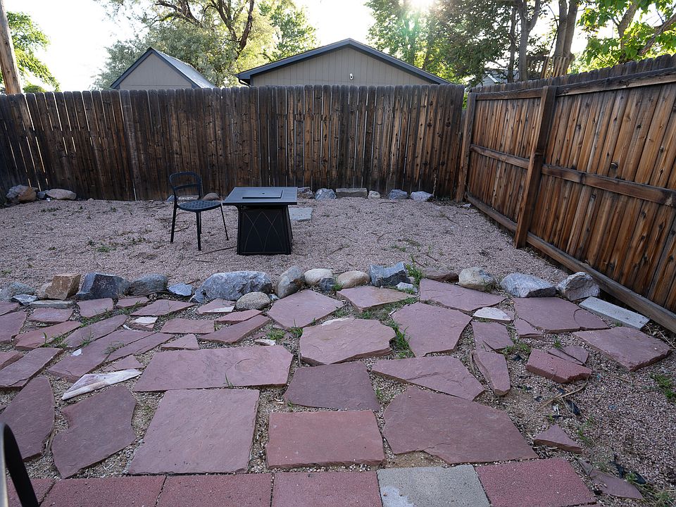 Gated, private back yard space with fire table.