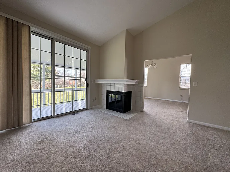 Gas Logs in Living Room. Walkthrough to Dining Area