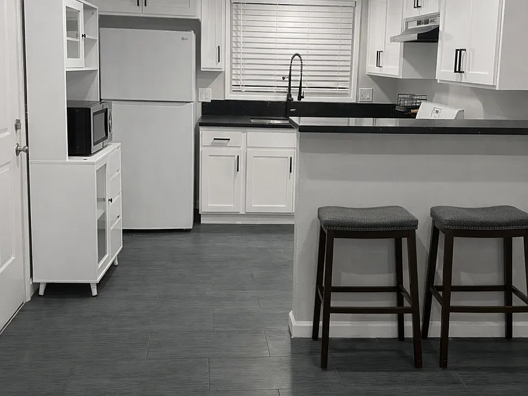Updated kitchen with granite countertops and breakfast bar seating for two. Stove, refrigerator, garbage disposal, microwave included.