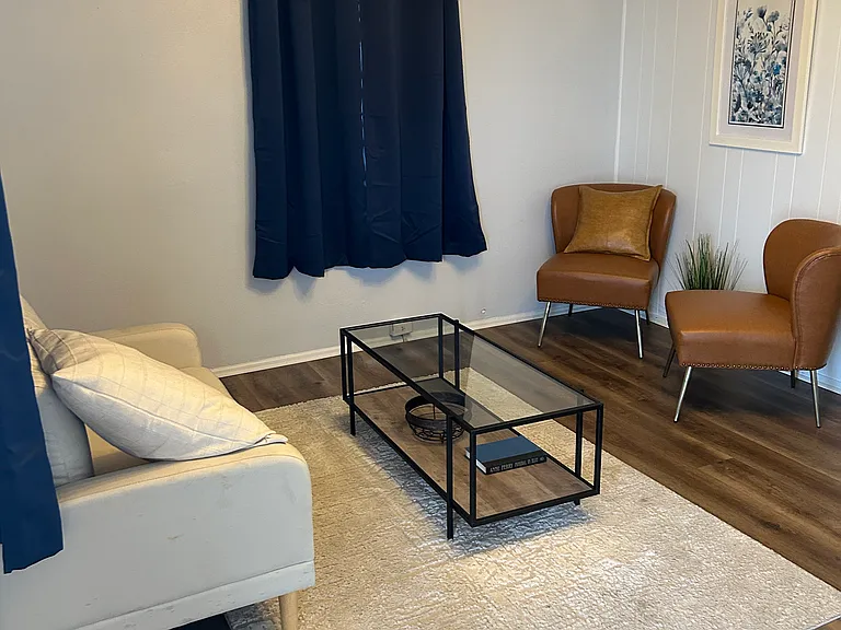 ENTRANCE LIVING ROOM; LOVE SEAT, TWO FAUX LEATHER CHAIRS, COFFEE TABLE, ETC.