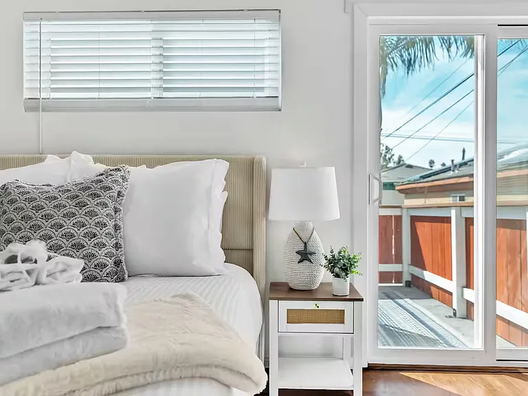 The bedroom 2 features a queen bed and direct access to the balcony