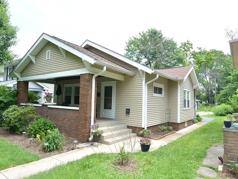 View from the street of house and covered front porch. Off street parking behind the house.
