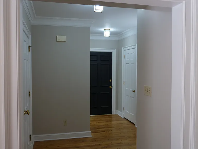 Front entrance foyer facing apartment entrance door.