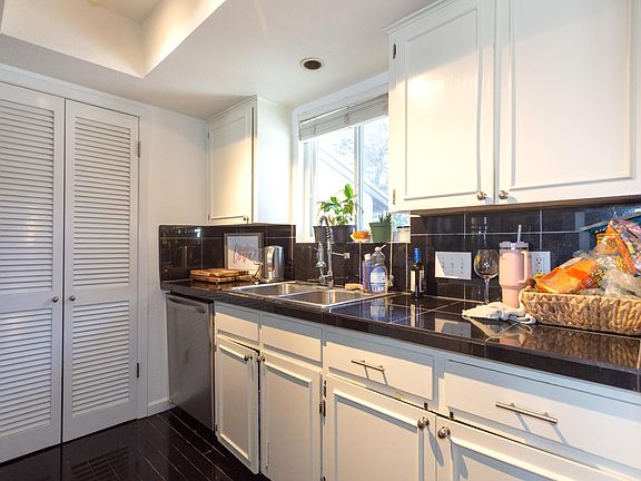 Galley Kitchen with Dishwasher and Pantry with Washer/Dryer hookups