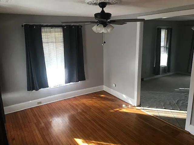 Dining room with new paint, curtains and lighting.