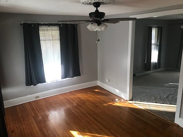 Dining room with new paint, curtains and lighting.
