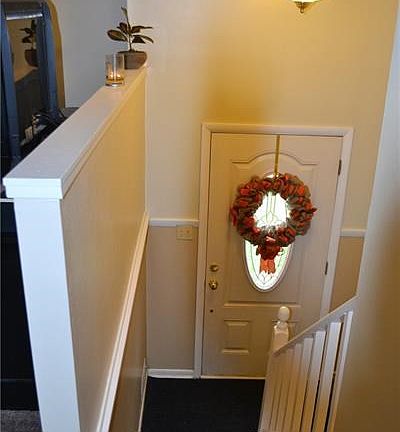 Entry with fresh paint and new carpeting.