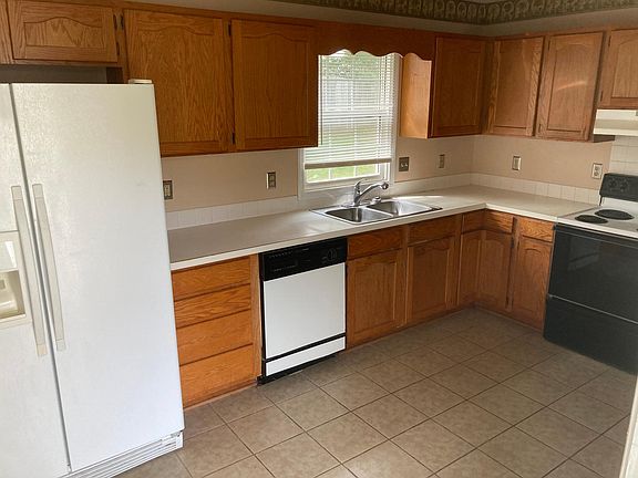 Kitchen w/ Breakfeast Nook and Ceramic Tile Floors. Side-by-Side Refrigerator, Stove, Dishwasher included. Laundry Room opens off Kitchen.