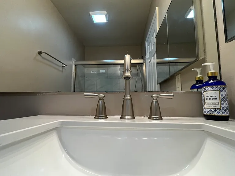 Updated Bathroom: 
Modern tile
Glass enclosure
Brushed nickel fixtures
