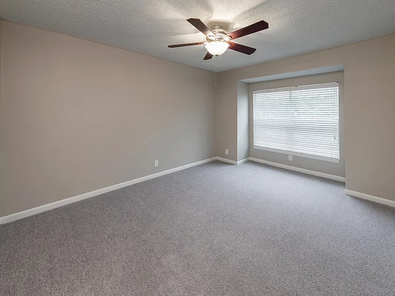 The Endeavor floor plan presents a spacious master suite with plush carpeting, a walk-in closet, and a stylish en suite for unparalleled relaxation.