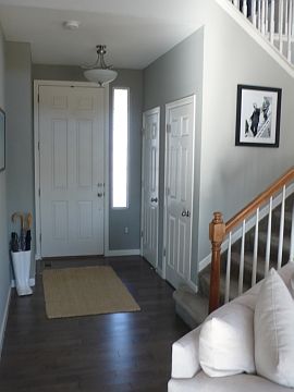 Stunning hardwoods &amp; custom gray paint create a warm welcome