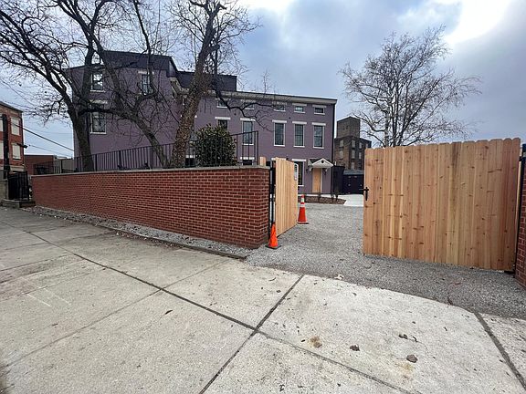 BRICK WALL AND WOOD GATE DRIVEWAY ENTRY