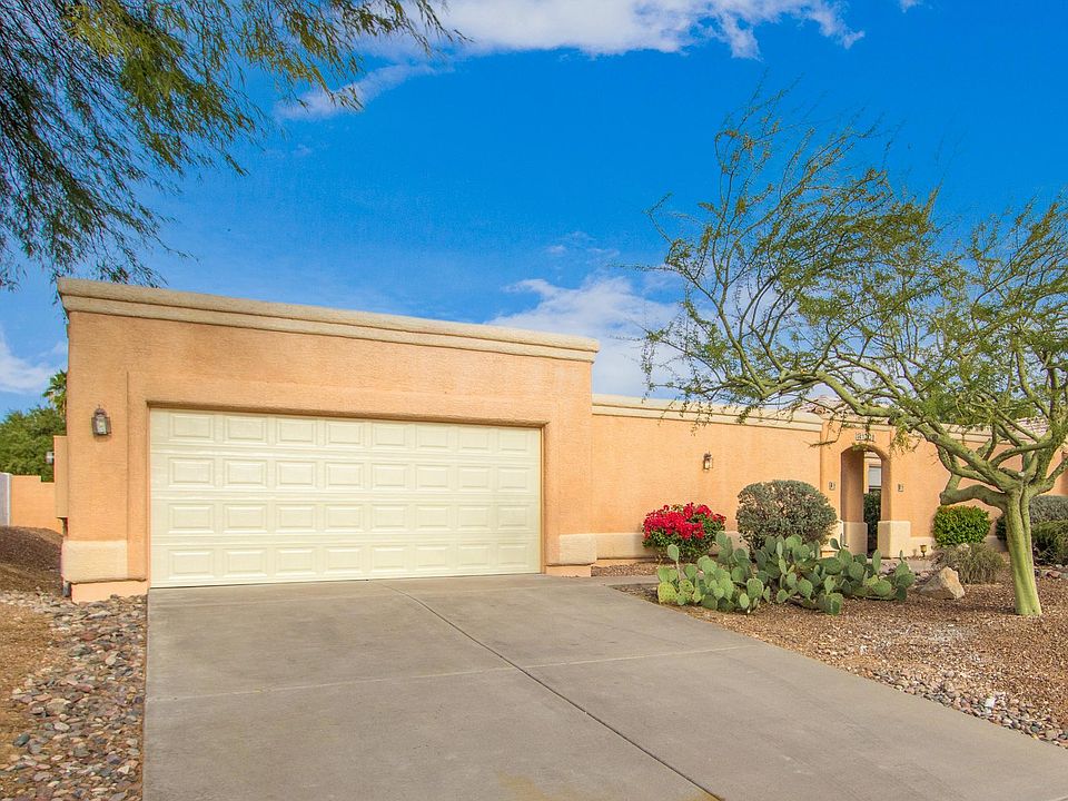 Street view of garage and entry to courtyard and front door